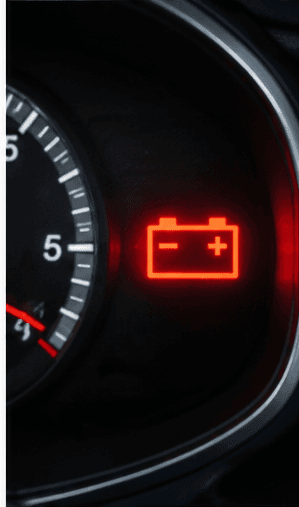 Battery warning light illuminated on a vehicle dashboard