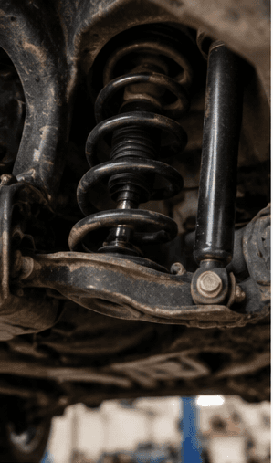 Close view of a vehicle suspension spring and shock absorber